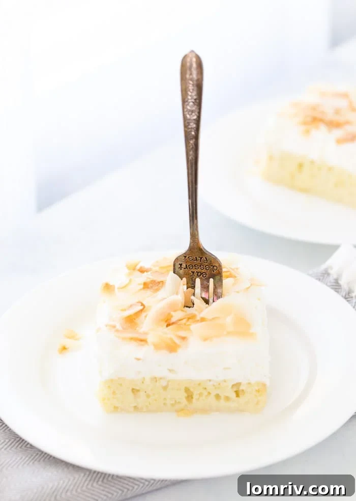 Coconut Tres Leches Cake: A moist sponge cake soaked in three coconut-infused milks, topped with fresh coconut whipped cream and dark rum.