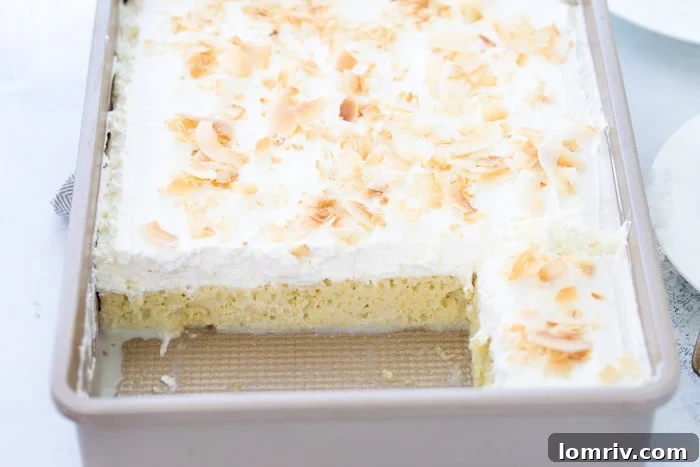 Coconut Tres Leches Cake: A moist sponge cake soaked in three coconut-infused milks, topped with fresh coconut whipped cream and dark rum.