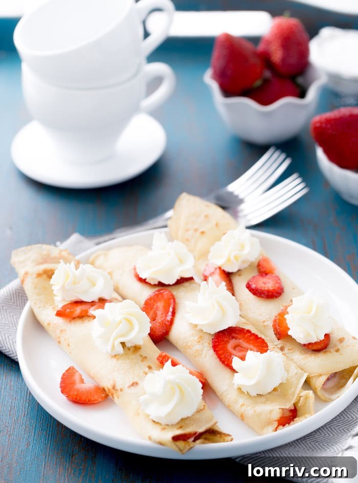 Delicate strawberry mascarpone crepes, a perfect sweet treat for brunch or dessert, filled with creamy Italian mascarpone and macerated fresh strawberries.