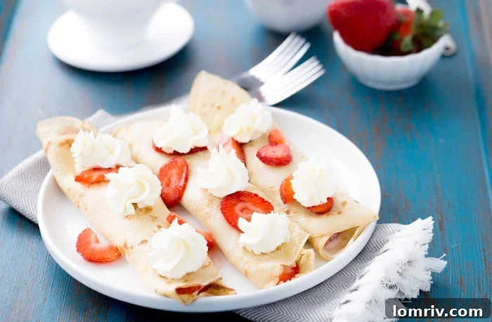 Close-up of fluffy strawberry mascarpone crepes, showcasing the creamy filling and fresh berries, ideal for a sweet breakfast or elegant dessert.
