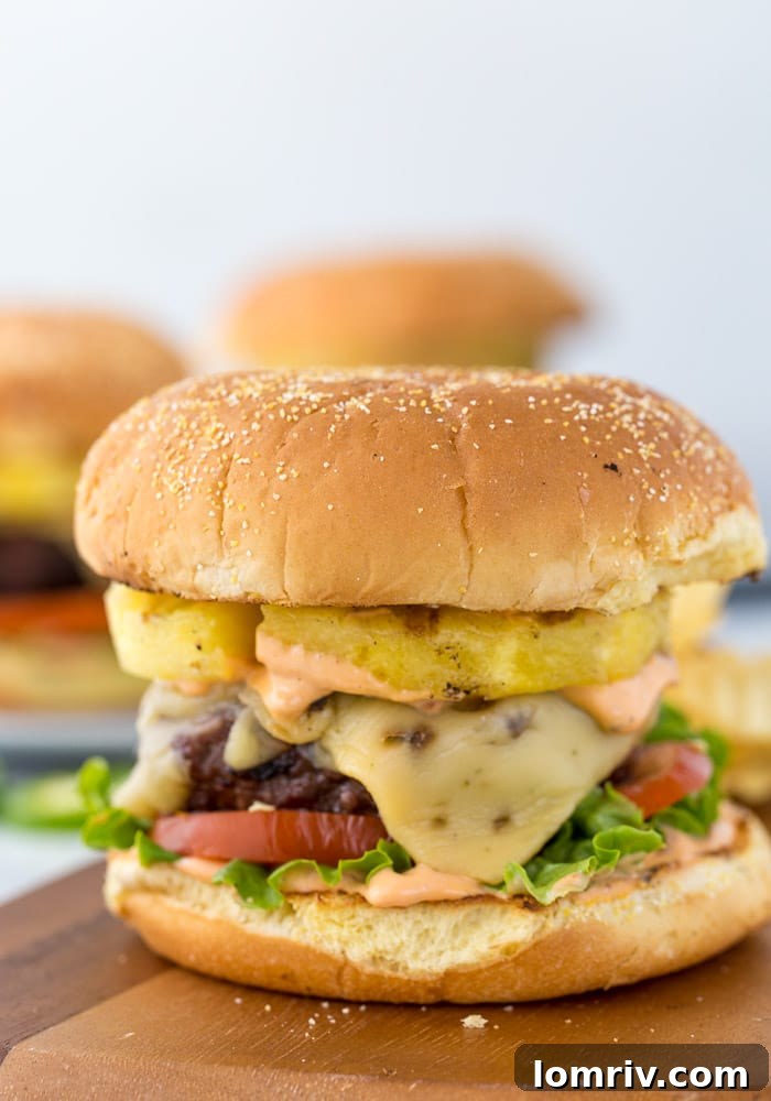 A beautifully presented Pineapple Jalapeno Burger, ready to be enjoyed, highlighting the vibrant toppings and toasted bun.