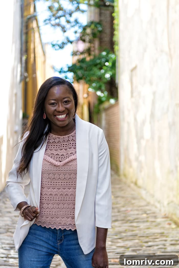 A classic white blazer adds effortless style to a casual outfit of jeans and a lace-detailed tank top for an evening out.
