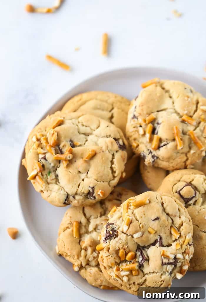 A stack of golden brown Butterscotch Pretzel Chocolate Chip Cookies, showcasing their appealing textures.