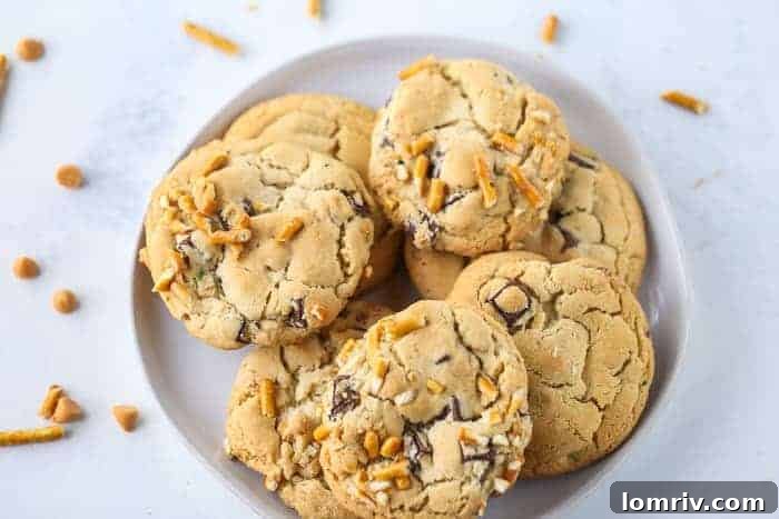 Freshly baked Butterscotch Pretzel Chocolate Chip Cookies cooling on a wire rack.