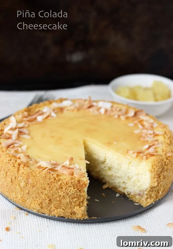 Beautifully Garnished Piña Colada Cheesecake on a Cake Stand, Ready to Serve