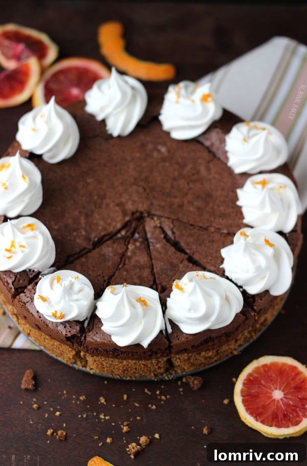 Overhead view of a Blood Orange Chocolate Truffle Torte, garnished with fresh blood orange slices, showcasing its elegant presentation.