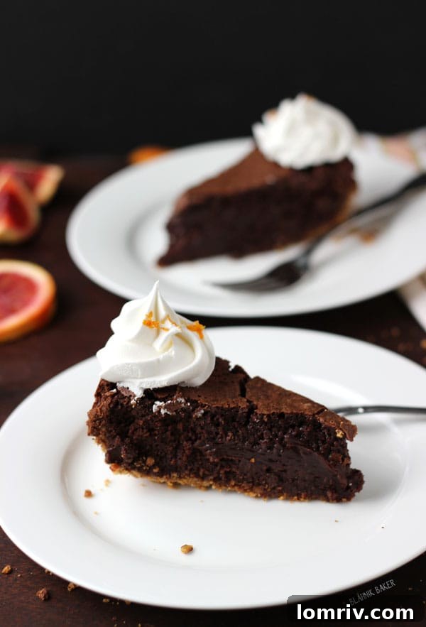 A close-up of the Blood Orange Chocolate Truffle Torte's texture, showing the smooth, dark chocolate filling and hints of citrus zest.