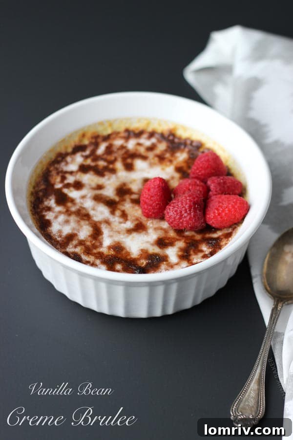 Close-up of Vanilla Bean Crème Brûlée texture, showcasing its creamy interior before caramelization