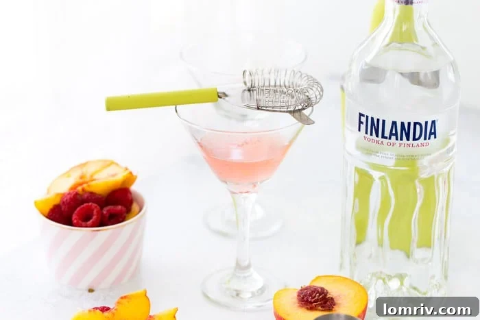 This summer peach raspberry martini recipe is filled with fresh raspberries and juicy peach flavors. A refreshing summer cocktail that's easy to whip up. 