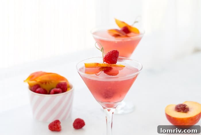 This summer peach raspberry martini recipe is filled with fresh raspberries and juicy peach flavors. A refreshing summer cocktail that's easy to whip up. 