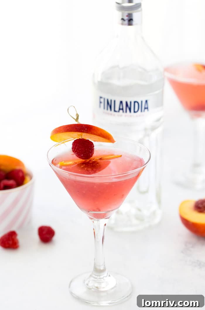 This summer peach raspberry martini recipe is filled with fresh raspberries and juicy peach flavors. A refreshing summer cocktail that's easy to whip up. 
