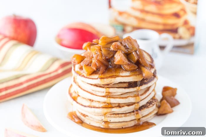 Close-up of golden-brown Apple Pie Protein Pancakes, showing their fluffy texture and the rich apple pie filling, ready to be enjoyed.