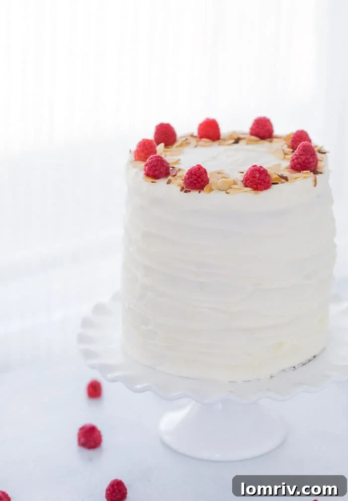 A luscious lemon raspberry cake, layered with zesty lemon cake, tangy raspberry compote, creamy honey mascarpone, and smooth cream cheese frosting.