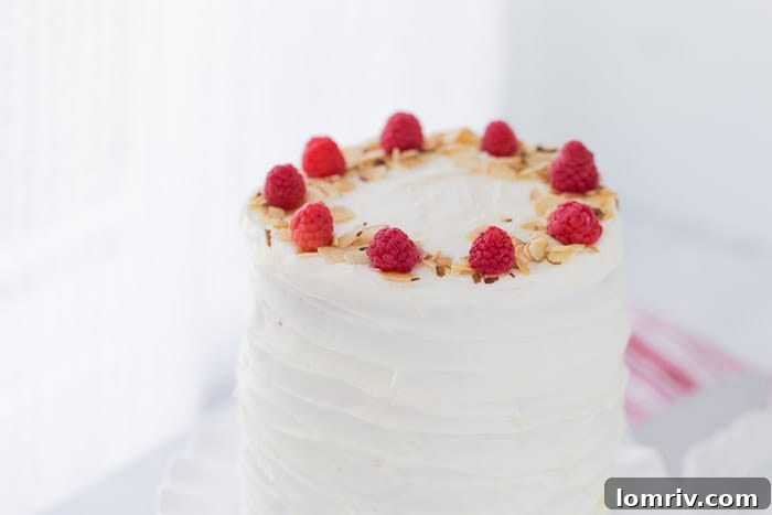 A finished lemon raspberry cake, beautifully decorated and ready to be served.