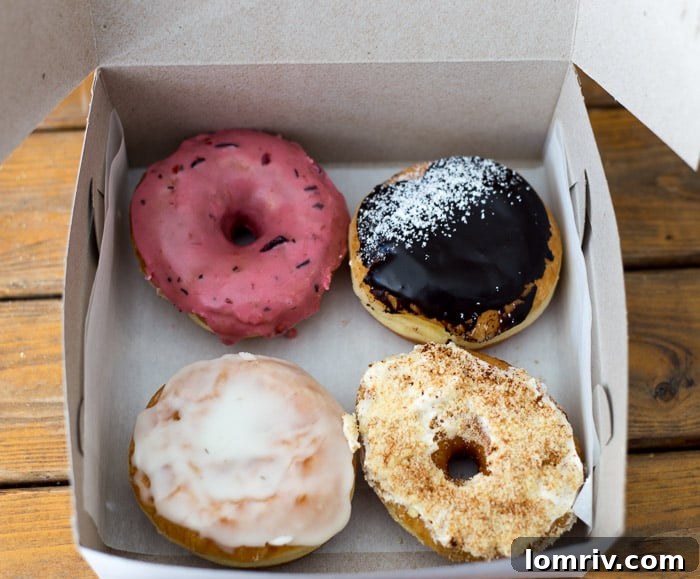 Another enticing view of specialty doughnuts, displaying rich glazes and intriguing textures, inviting visitors to Toronto's best dessert spots.
