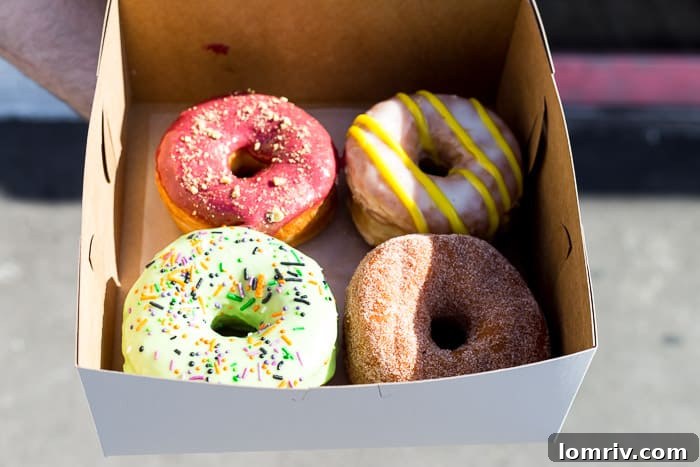 An array of freshly baked, gourmet doughnuts in various flavors, representing the diverse and delightful offerings found in Toronto's bakeries.