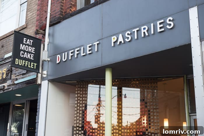 A decadent slice of cake from Dufflet Pastries, featuring multiple layers and rich frosting, showcasing Toronto's classic cake destinations.