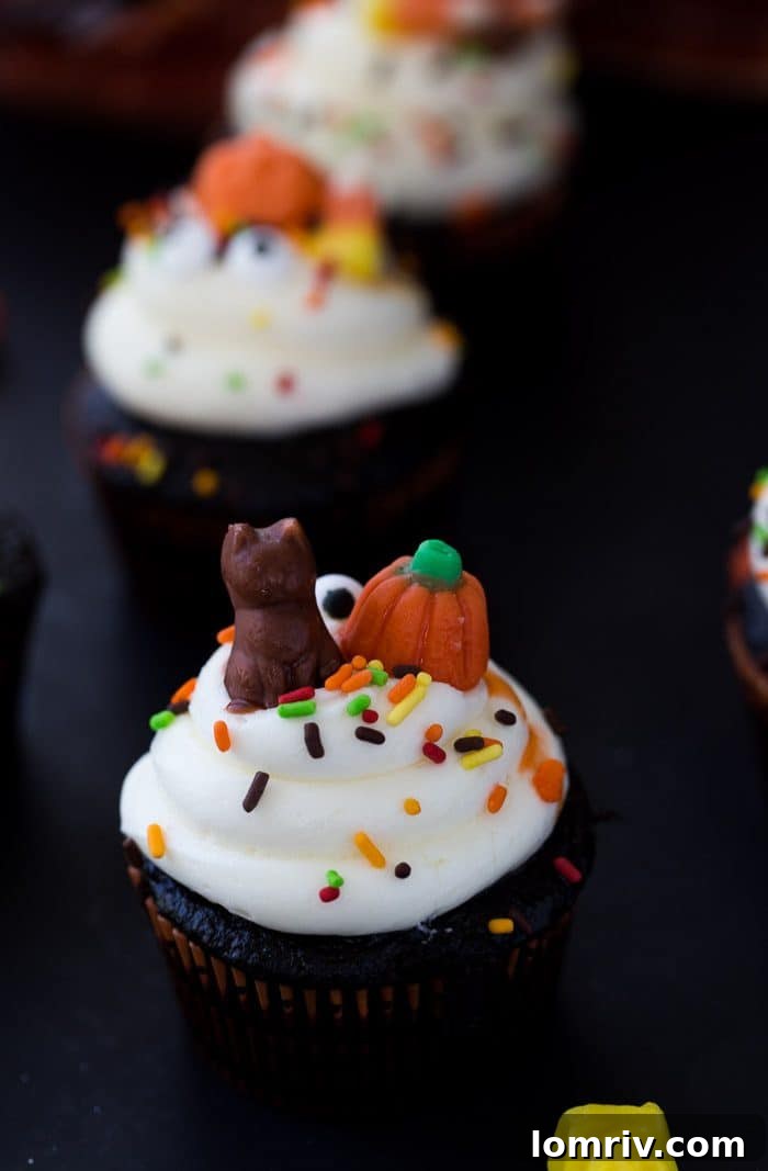A close-up of a chocolate Halloween cupcake decorated with white frosting and edible eyes, showcasing easy and creative holiday dessert ideas.