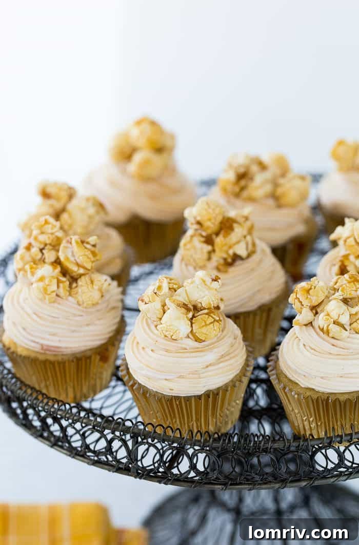 Three Caramel Corn Cupcakes with caramel drizzle and caramel corn topping