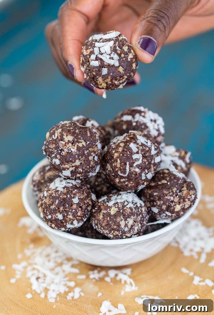 A close-up of several homemade brownie energy bites, showcasing their wholesome texture and inviting cocoa color, ready to be enjoyed as a perfect pick-me-up.