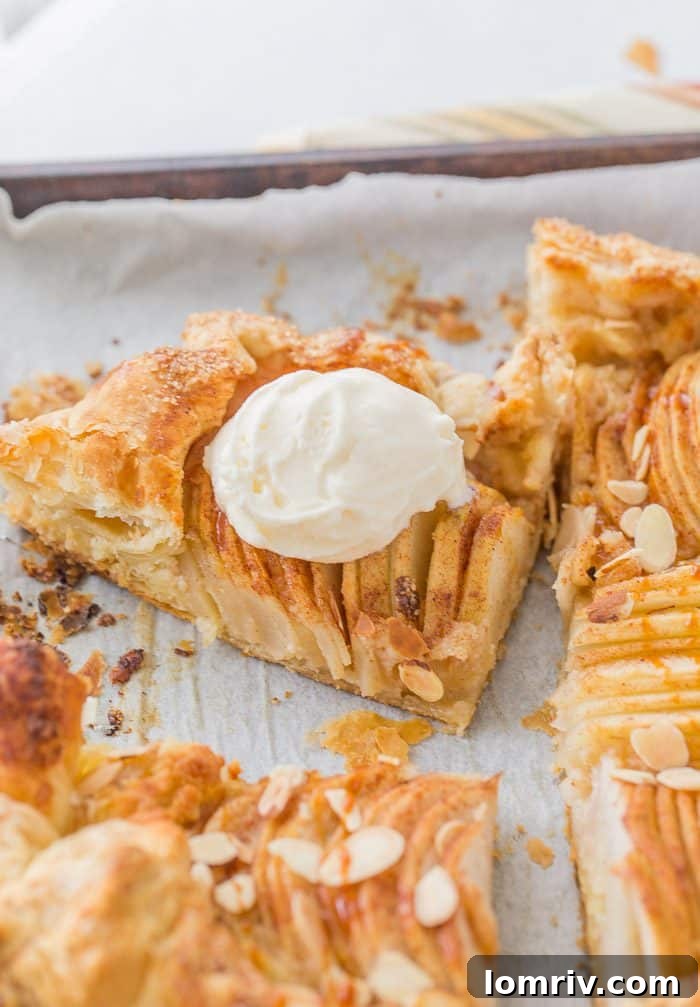 A whole pear almond galette, fresh from the oven, cooling on a wire rack. Its freeform edges and golden crust hint at the delightful flavors within, ready to be enjoyed as a perfect fall dessert.