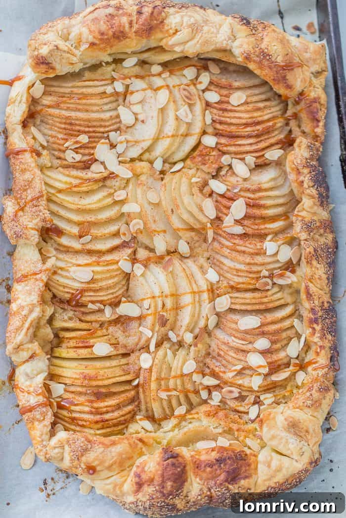 A slice of the pear almond galette on a plate, revealing the layers of flaky crust, almond frangipane, and perfectly cooked pears. Ready to be served and savored.