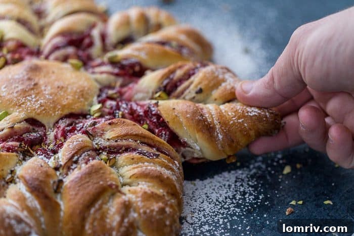 This Cranberry Cinnamon Star Bread is a holiday spectacular with a warm cranberry, brie and pistachio filling wrapped around a fluffy bread. 