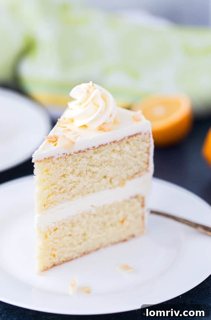 Overhead shot of the full Meyer Lemon Coconut Cake with lemon and coconut garnishes
