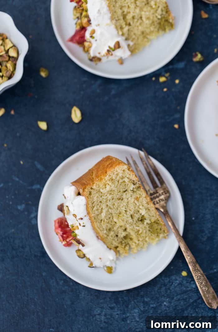 Slice of Orange Chiffon Cake Revealing Swirls of Pistachio and Cardamom