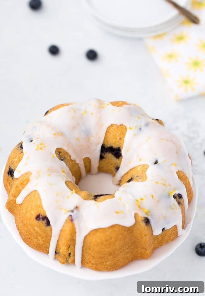 Blueberry Lemon Pound Cake topped with a delicate lemon glaze, ready to be served.