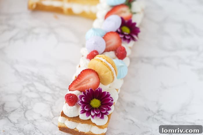 A close-up shot of a number '7' cake, beautifully decorated with an assortment of fresh berries, delicate meringue, and other edible adornments.