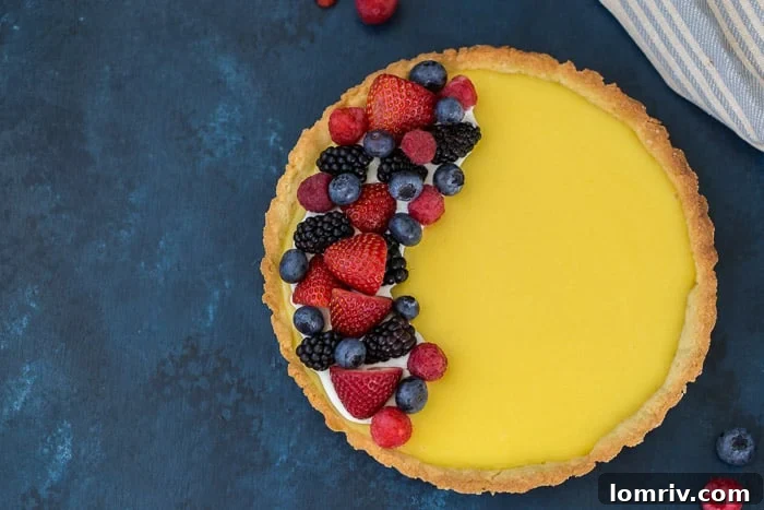 Slice of Classic Lemon Tart with Fresh Berries and Whipped Cream