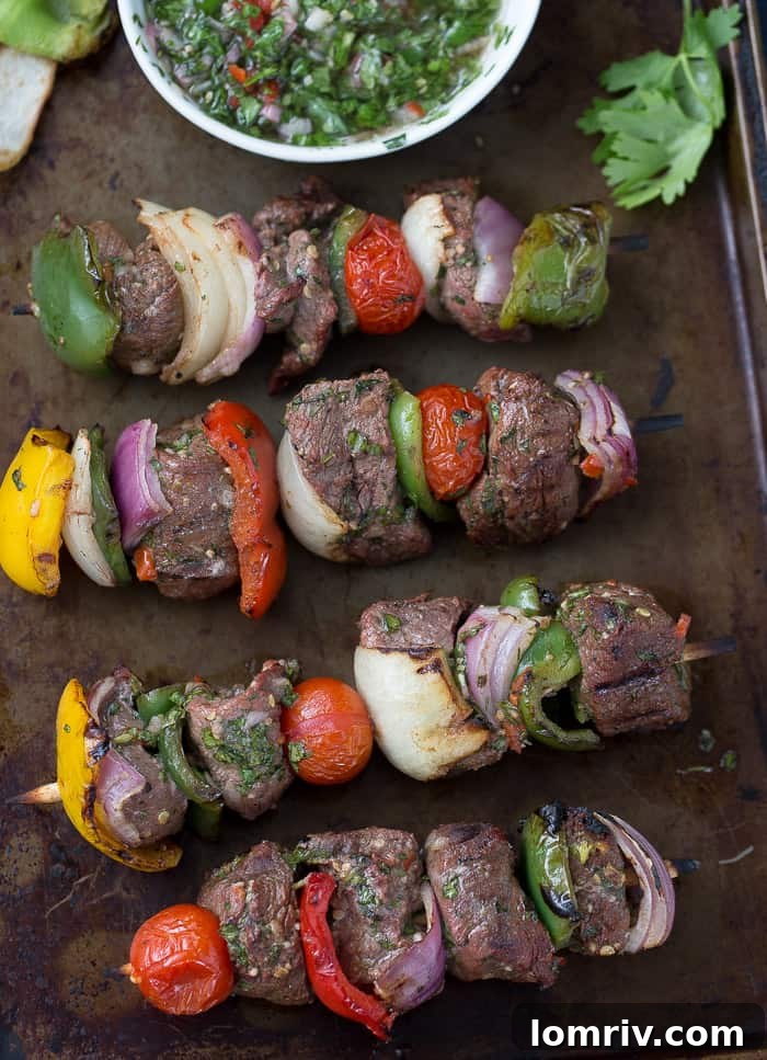 Cooked Beef Kebabs with Chimichurri Sauce on a Platter, Ready to Serve