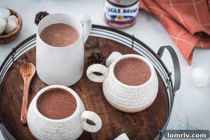 A festive table setting with Gingerbread Hot Chocolate mugs and holiday decorations
