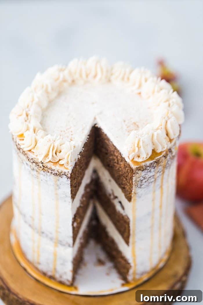 A top-down view of the beautifully decorated apple spice cake, showing the texture of the cinnamon frosting and the glistening caramel drizzle.