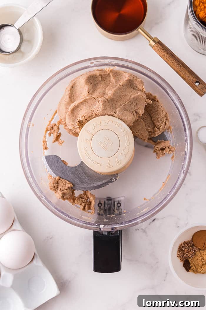 Pumpkin tart ingredients in a food processor.