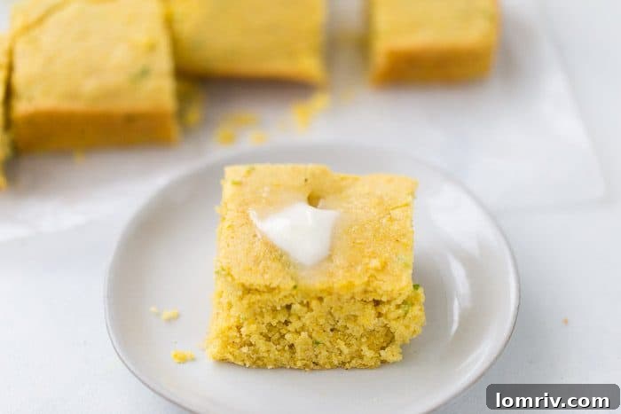 A slice of warm homemade Jalapeño Buttermilk Cornbread ready to be served
