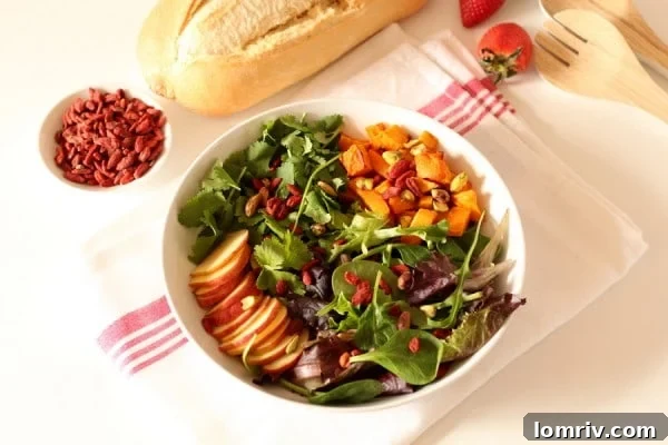 Close-up of a delicious roasted butternut and goji berry salad with fresh greens.