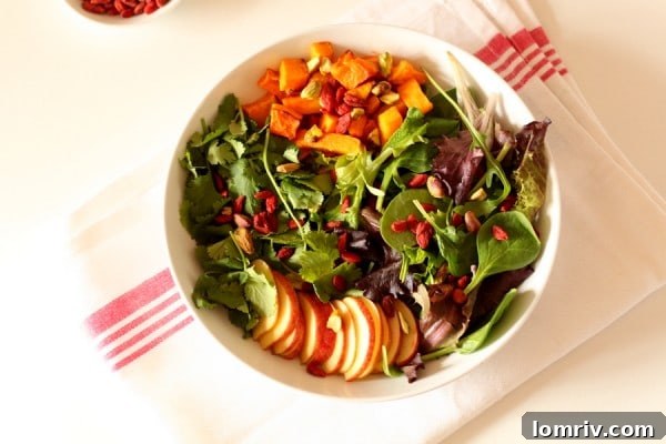 A beautifully arranged roasted butternut and goji berry salad with balsamic dressing.