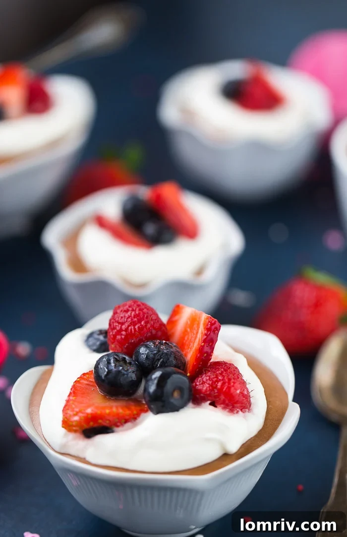 Rich and creamy Peanut Butter Chocolate Mousse topped with fresh berries, ideal for Valentine's Day.