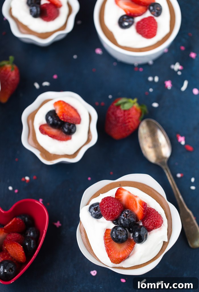 Peanut Butter Chocolate Mousse in a glass, ready for a garnish of fresh berries.