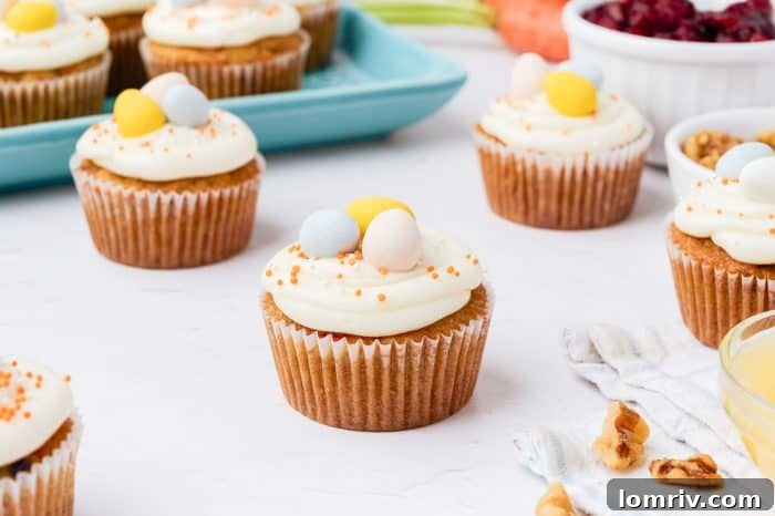 A collection of beautifully decorated carrot cake cupcakes.