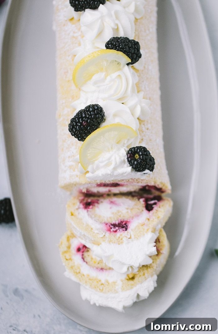 Garnished Blackberry Lemon Roll Cake ready to serve