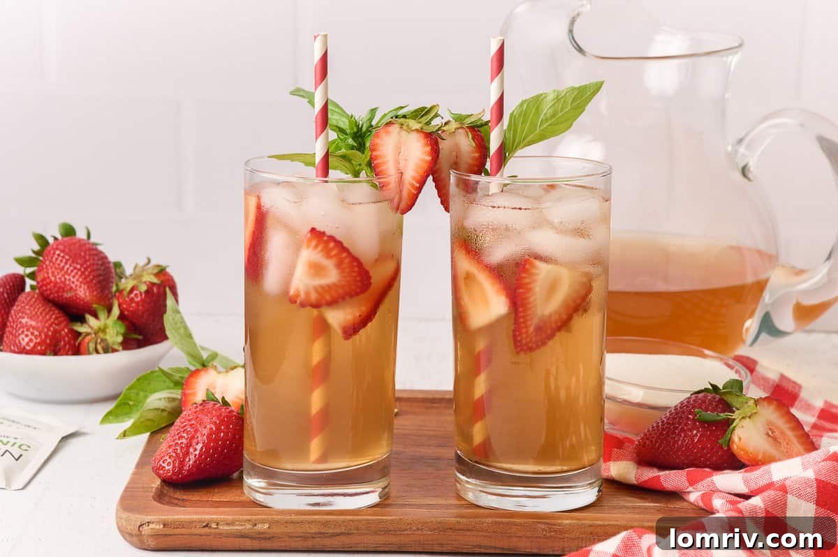 Strawberry Basil Iced Tea in a pitcher with glasses