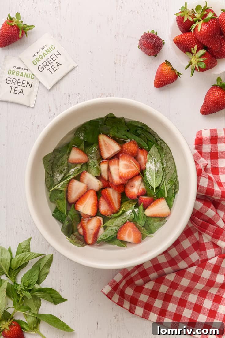 Chopped strawberries, basil, and sugar in hot water