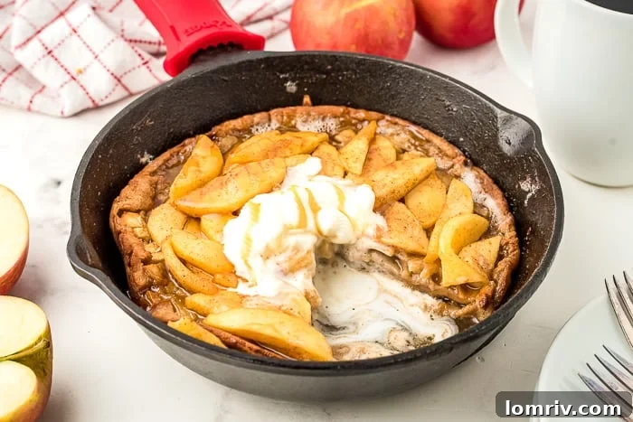Caramel Apple Dutch Baby Pancakes cooked in a cast iron skillet