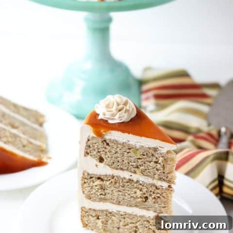 A rich spiced apple cake topped with salted caramel frosting and sauce.