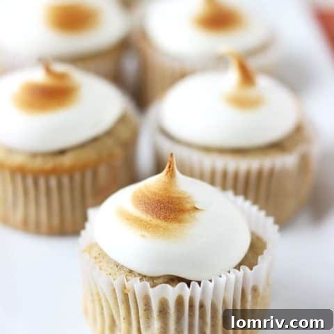 Moist spiced apple cupcakes with fluffy maple marshmallow frosting.