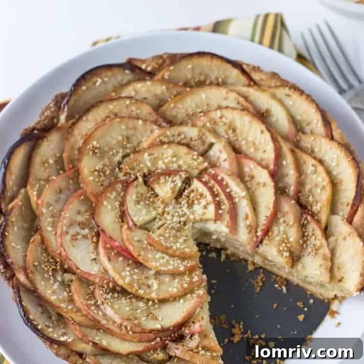 An elegant apple tart garnished with toasted sesame seeds.