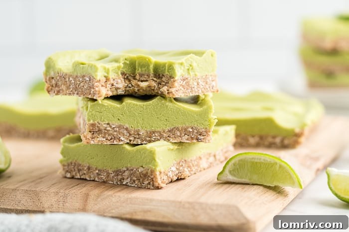 Close-up of a single Vegan Key Lime Pie Bar, showcasing its creamy filling and wholesome crust on a minimalist background.